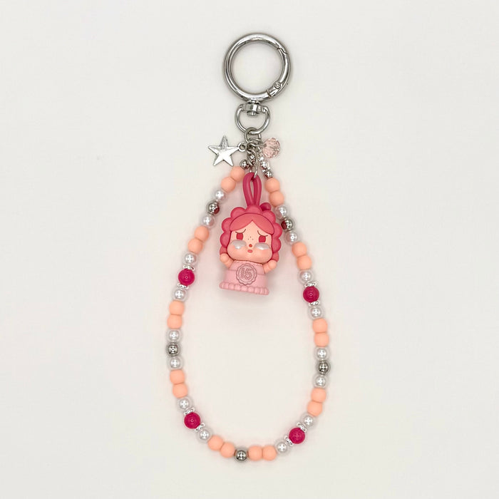 Keychain with cartoon character and beaded chain on a white background