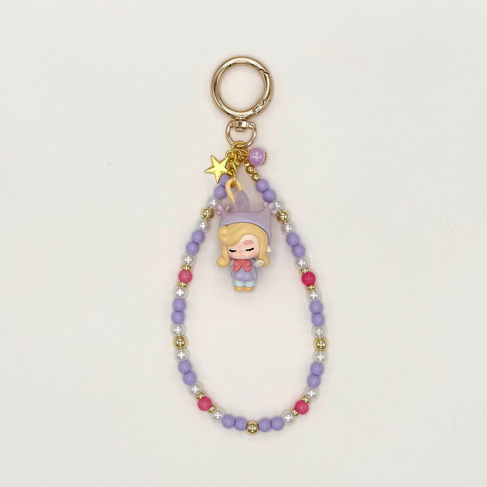 Keychain with a character charm and beaded chain on a light gray background