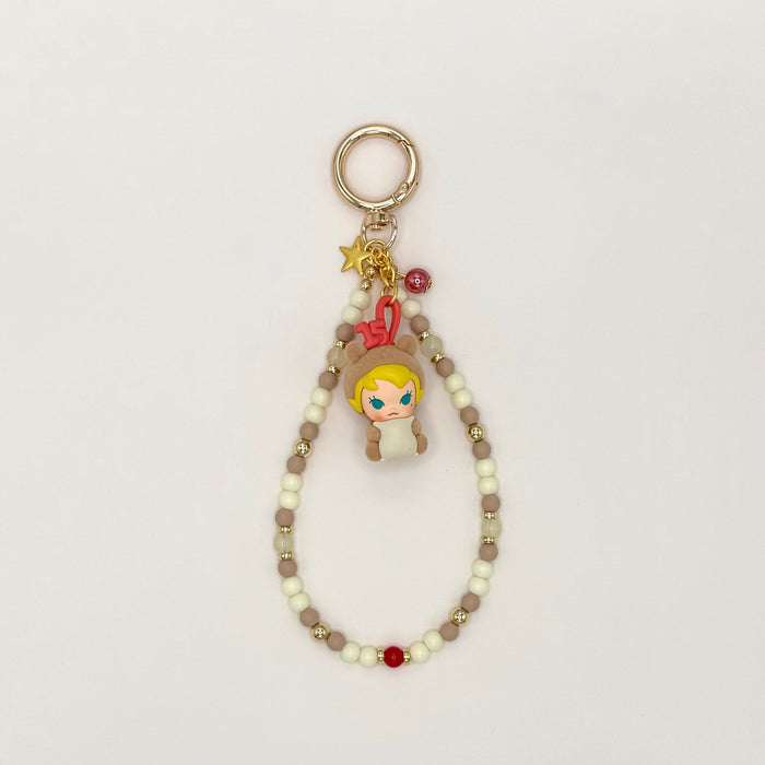 Keychain with character charm and beaded chain on a light gray background