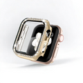 A gold Apple Watch with a rectangular screen is displayed. The watch features a luxurious Coconut Lane 2-in-1 Apple Watch Case & Built-In Screen Protector - Gold Diamante, which partially covers the screen with its sparkling, diamond-encrusted design. The crown button and a portion of the digital display showing the time are visible. The background is plain white.