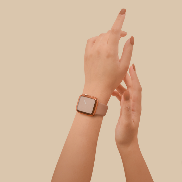 Hand wearing a rose gold metallic Coconut Lane 2-in-1 Apple Watch case with built-in screen protector raised.