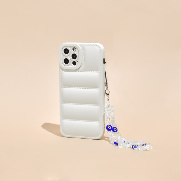 White quilted phone case with a beaded Crystal Evil Eye strap, shown on a beige background.