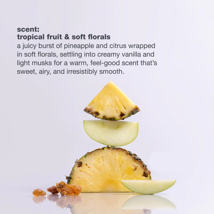 Sliced pineapple on a reflective surface with descriptive text about its scent.