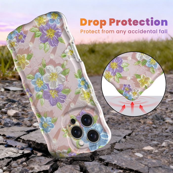 Soft pink wavy iPhone case featuring painterly flowers in purple, blue, and yellow with a glossy finish.