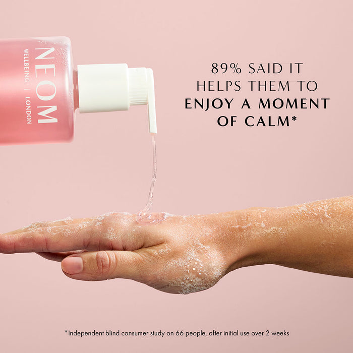 NEOM Complete Bliss hand wash being dispensed onto hand with text about enjoying a moment of calm