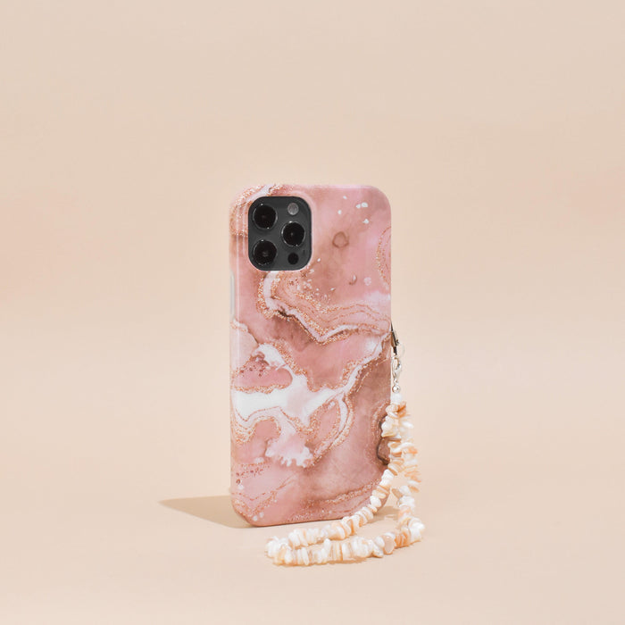 Coconut Lane nude phone case with a clear crystal strap, standing upright on a plain neutral background.