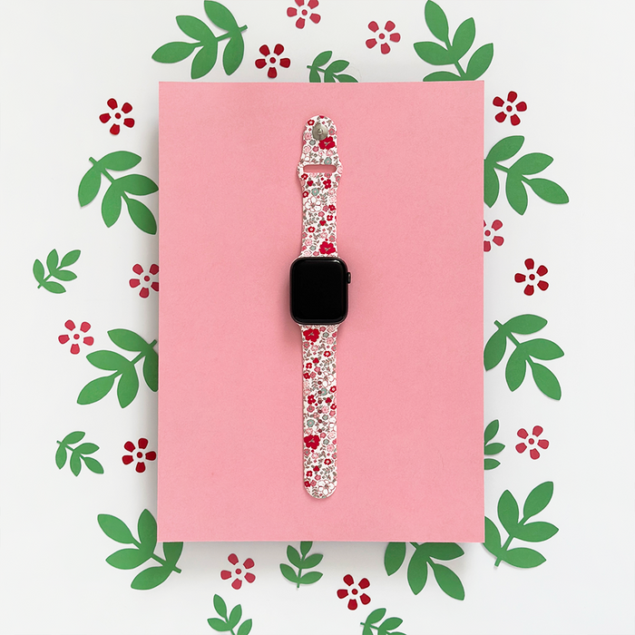 Apple Watch strap with a red flower and green leaf floral pattern from Coconut Lane.