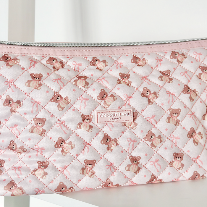 Pink quilted expandable makeup bag with teddy bear and bow pattern, by Coconut Lane.