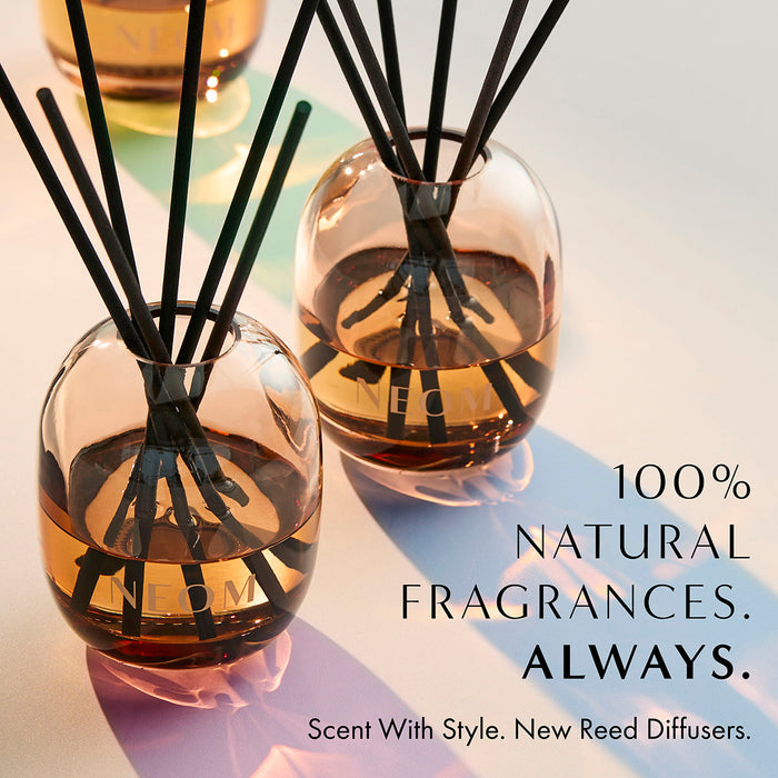 NEOM reed diffuser in amber glass bottle with black reeds, natural home fragrance with stylish design