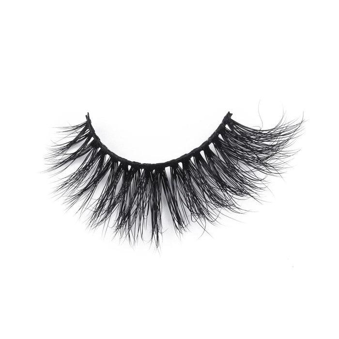 A single strip of dramatic, thick, black false eyelashes with a crisscross pattern is showcased on a white background for a bold and glamorous look.