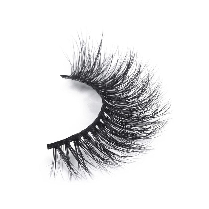 A single dramatic, black false eyelash with wispy, voluminous fibers displayed on a white background, perfect for bold glamour.