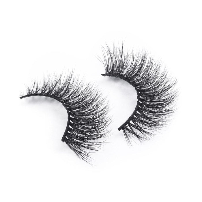 A pair of dramatic, thick, and long faux mink eyelashes with wispy black fibers, displayed on a white background.
