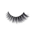 A single strip of dramatic, thick, and wispy false eyelashes with a black band on a plain white background for bold eye looks.