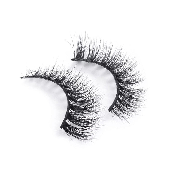 Dramatic black wispy false eyelashes with a thick band, perfect for bold makeup looks, displayed on a white background.