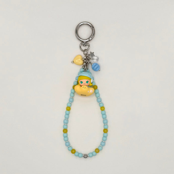 Beaded keychain with character charm on a light gray background