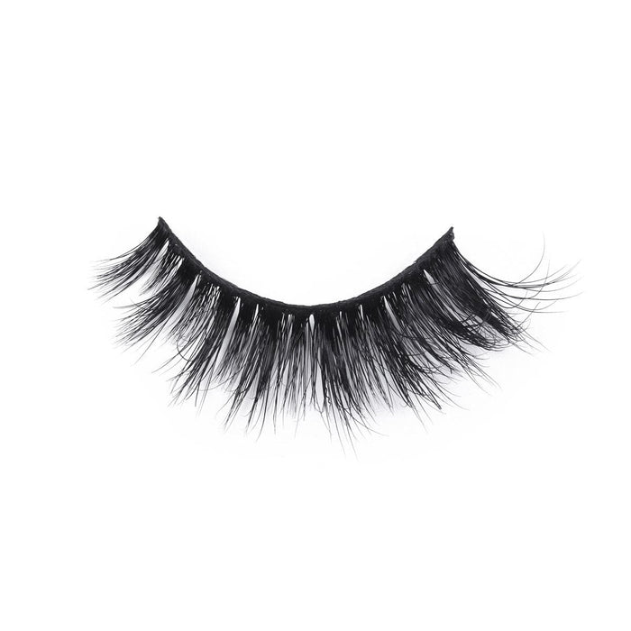 A single false eyelash strip with thick, long, wispy black lashes, slightly curved for a dramatic look against a white background.