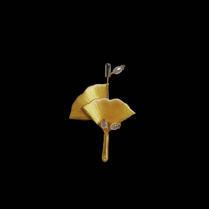Handcrafted Chanhua ginkgo leaf brooch featuring golden yellow thread-wrapped leaves and delicate pearl accents.
