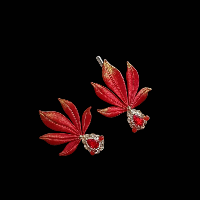 Handcrafted Chanhua goldfish brooch in red and gold thread-wrapped silk with a central red gemstone.