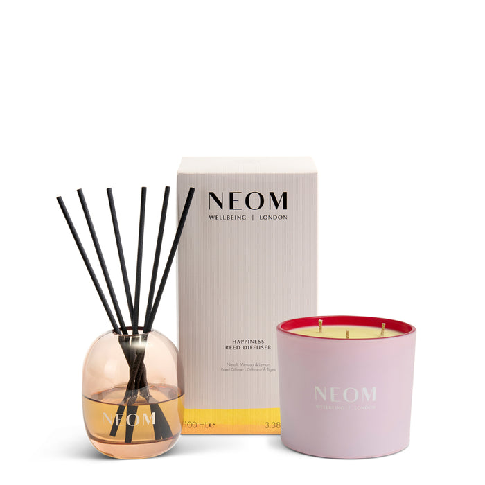 NEOM Happiness reed diffuser and it's all rosy 3 wick candle on a white background