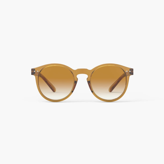 Golden yellow sunglasses with gradient lenses on a white background