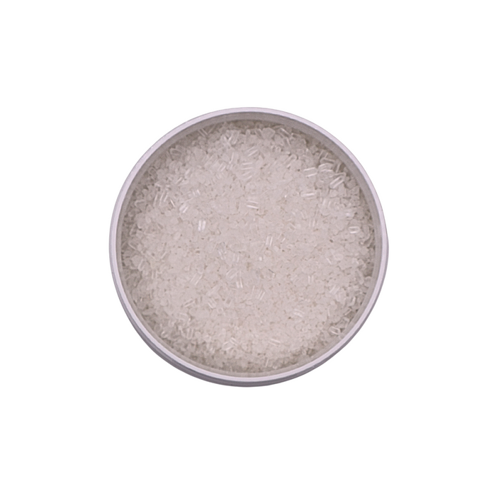 Silver colored powder in a round container on a white background