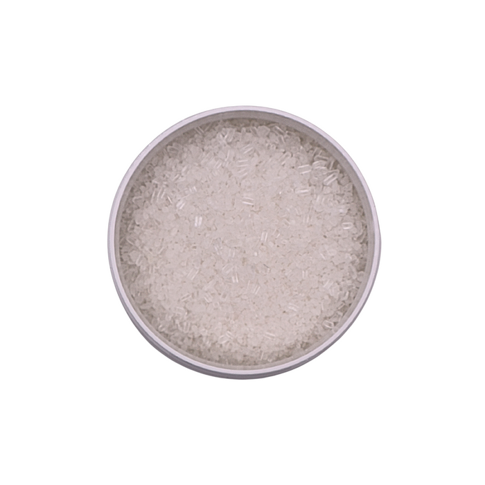 Silver colored powder in a round container on a white background