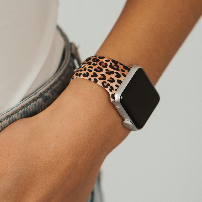 Leopard print Apple Watch strap by Coconut Lane paired with a white top and blue denim jeans.
