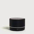 Black cylindrical portable diffuser on a light gray background