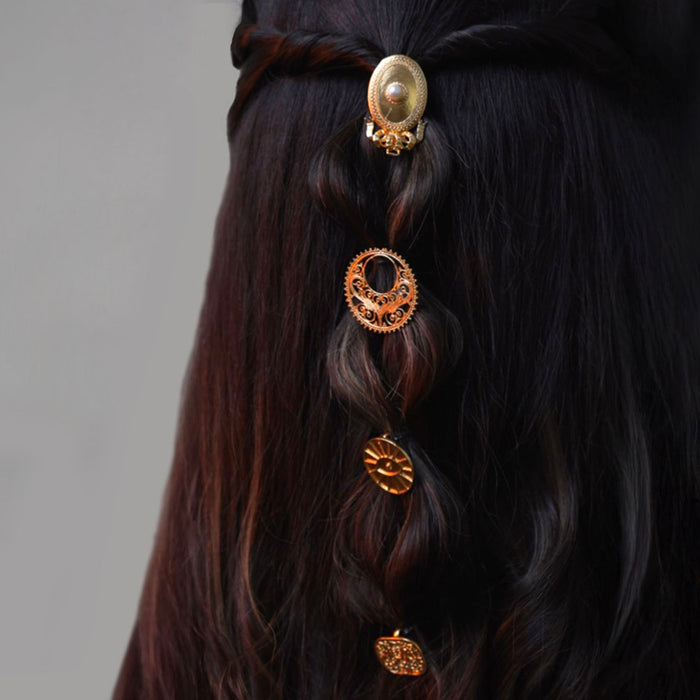 Elegant gold Mohar juda pins bringing a rich traditional touch to wedding hairstyles