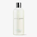 Molton Brown conditioner bottle on a white background