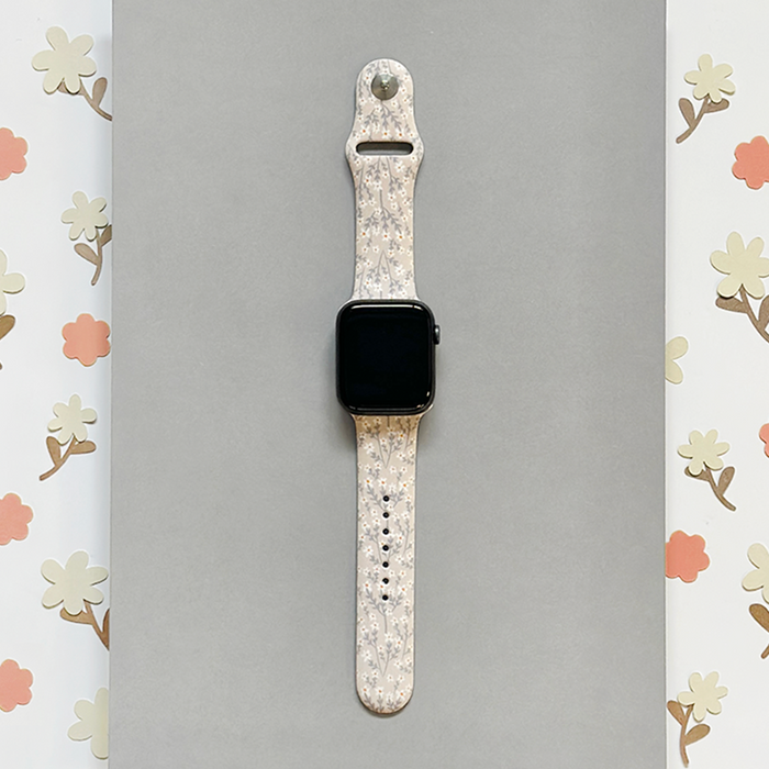 Gray Apple Watch strap with nude floral pattern and matching floral border.