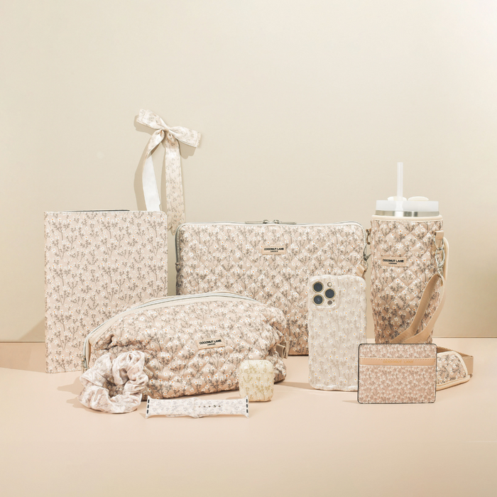 Nude floral Apple Watch strap and matching accessories arranged on a beige background.