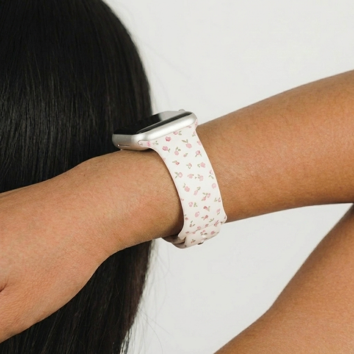 Pink Watercolour Flowers Apple Watch strap by Coconut Lane worn on a wrist, featuring a floral pink and white pattern.