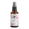 A 50ml amber glass spray bottle of Perfect Potion Relax Aromatic Mist, featuring a white label with pink and purple floral illustrations and a black spray nozzle, set against a plain white background.
