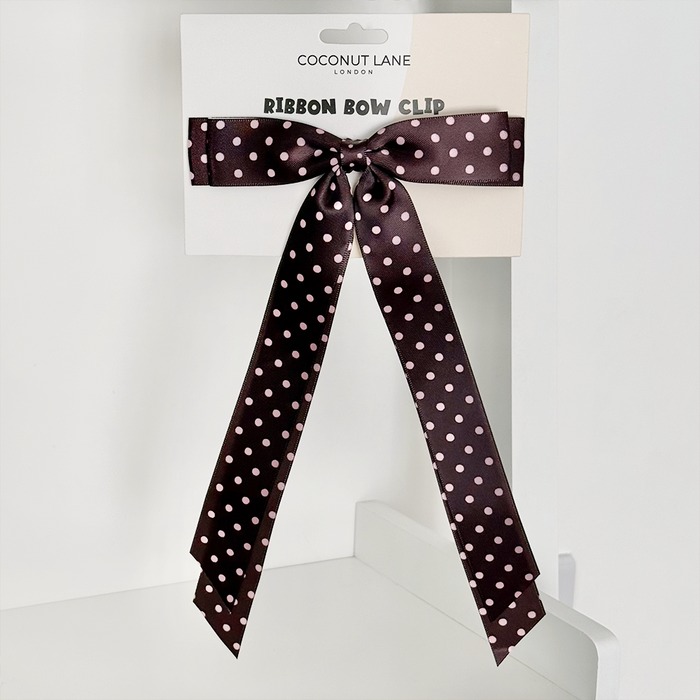 Brown polka dot ribbon bow hair clip on a Coconut Lane branded card.