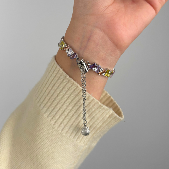Silver Coconut Lane Riviera Crystals Apple Watch strap worn on a hand, shown against a plain background.