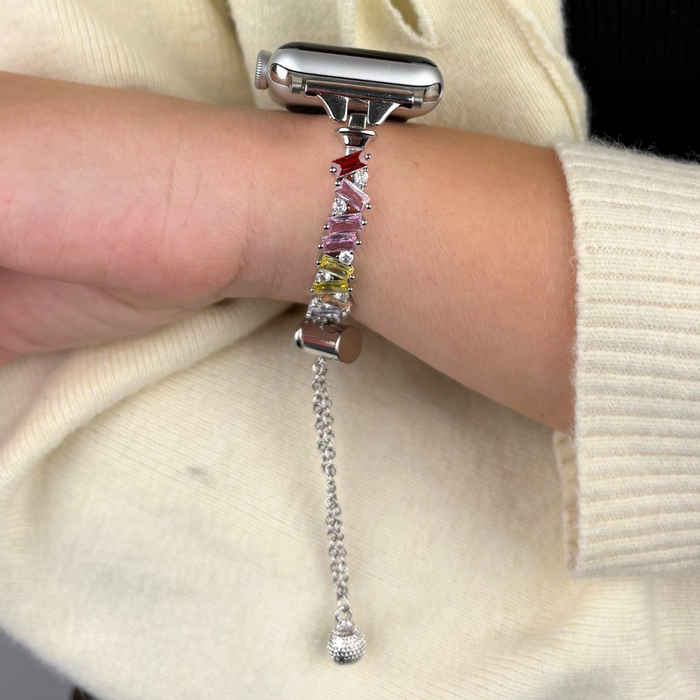 Silver Apple Watch strap with crystal gemstones by Coconut Lane, shown on a wrist over a cream sweater.