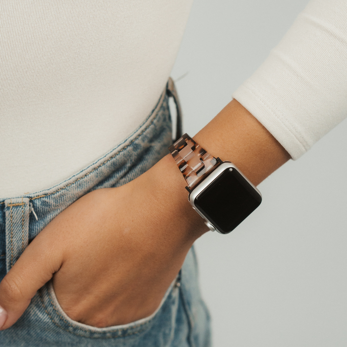 Coconut Lane Slim Luxe Ivory Tort Apple Watch Strap on wrist with blue jeans, hand resting in pocket.