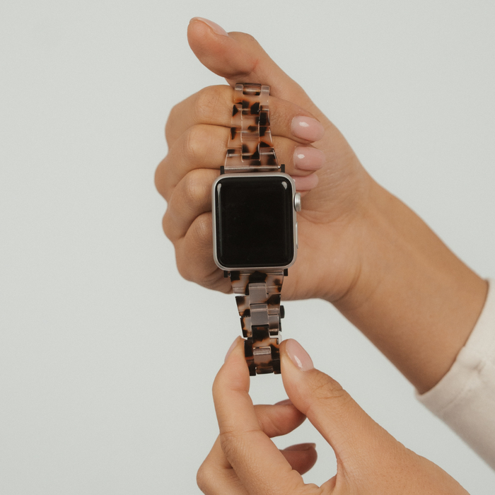 Slim Luxe Ivory Tort Apple Watch strap by Coconut Lane, held in hand against a plain light background.