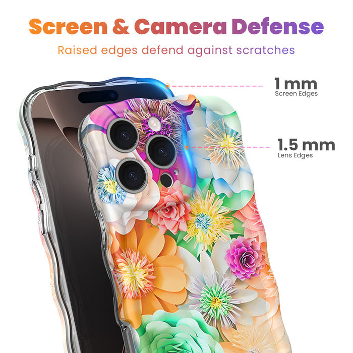 Hand holding a vibrant floral iPhone case featuring roses, daisies, and colorful blooms in pink, teal, and yellow with wavy edges.