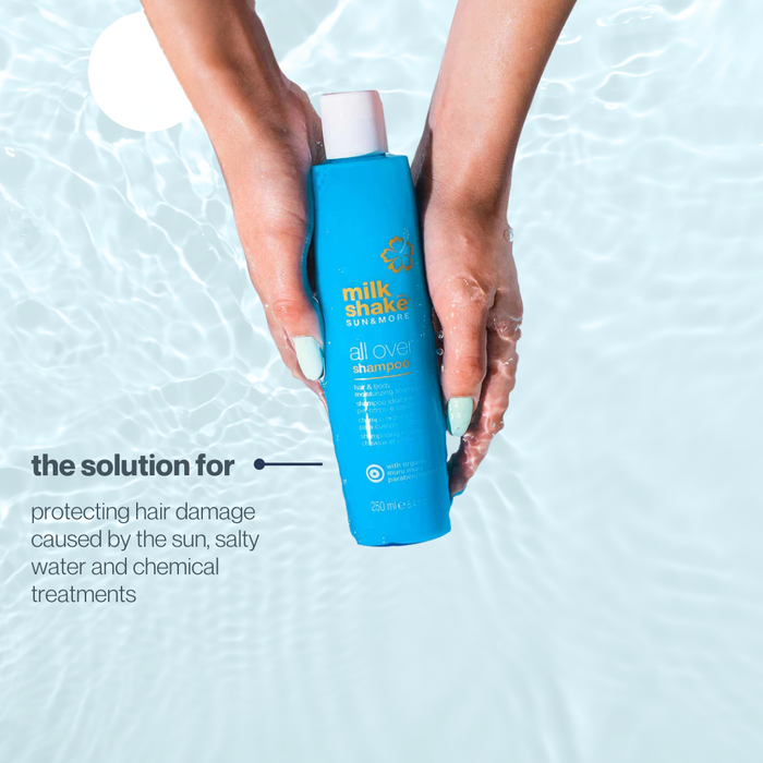 Hand holding a blue bottle of milk_shake SUN&MORE shampoo with text about hair care solutions.