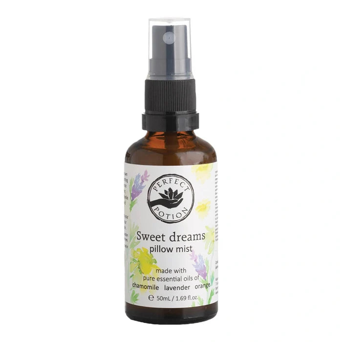 A 50ml amber glass spray bottle of Perfect Potion 'Sweet dreams pillow mist' with a black spray cap and a white label decorated with yellow and purple floral illustrations.