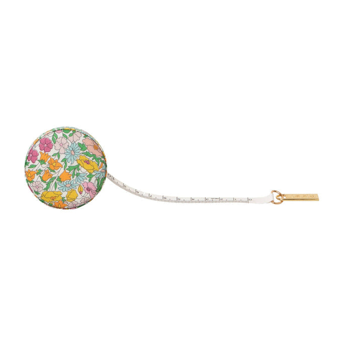 Round floral measuring tape on a white background