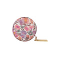 Round floral-patternedmeasuring tapeon a white background