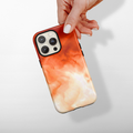 Hand holding a beige Coconut Lane Tough MagSafe® phone case with Iced Latte pattern on a plain light background.
