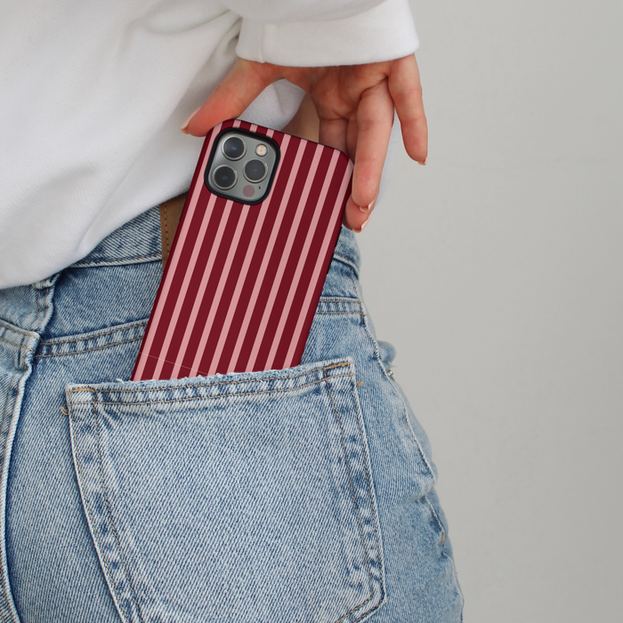 Mulberry Stripes Coconut Lane Tough Phone Case with dual layers being slipped into a blue jeans pocket.