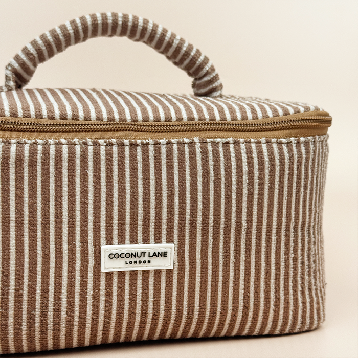 Chestnut striped vanity case with a handle and gold zipper, from Coconut Lane.