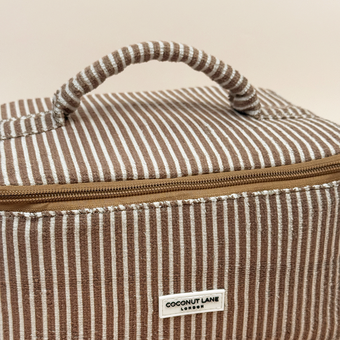 Chestnut striped Coconut Lane vanity case with top handle, zipper closure, and front label.