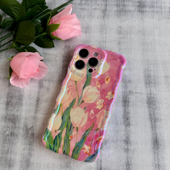 Pink wavy iPhone case featuring painterly white and pink tulips with green stems and iridescent finish.