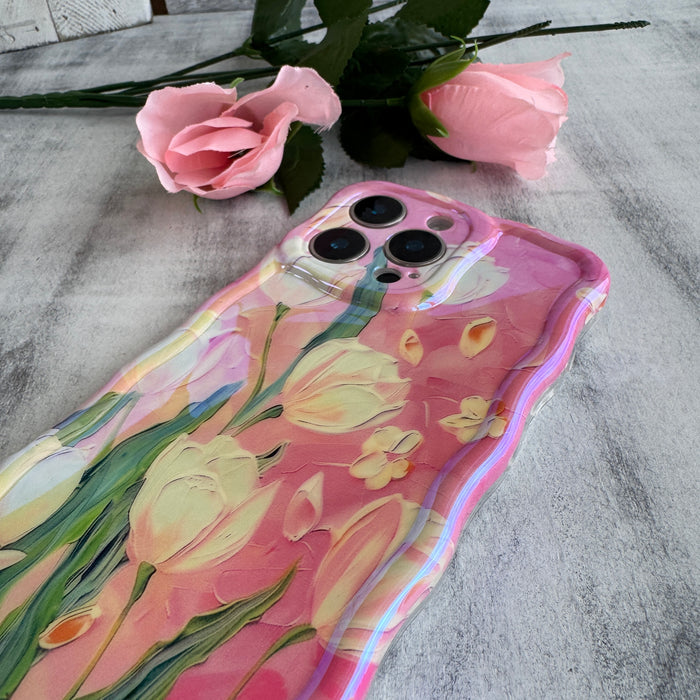 Pink wavy iPhone case featuring painterly white and pink tulips with green stems and iridescent finish.
